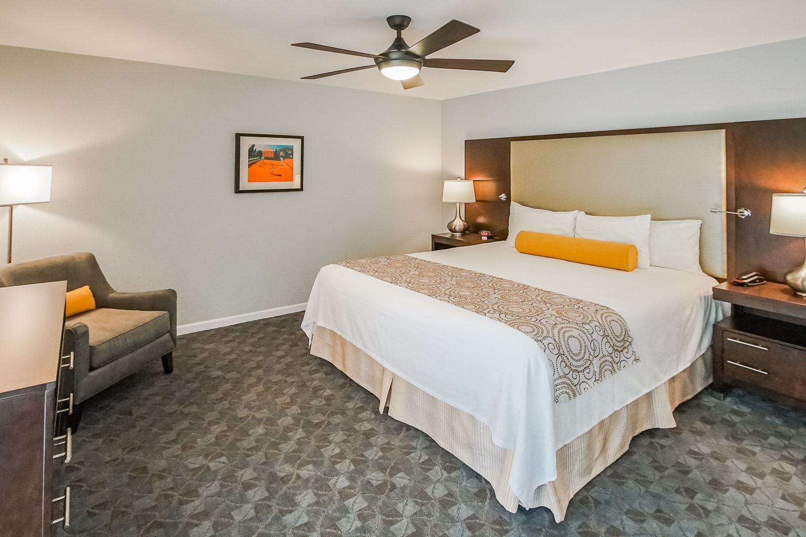 An expansive master bedroom with a king size bed at VRI's Palm Springs Tennis Club in California.